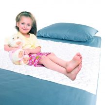 Waterproof bedding overlay with girl sitting on bed